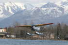 Cessna float plane taking off